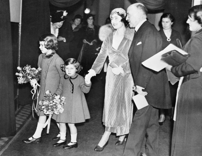 <p>Just a few days later, Princess Elizabeth returned to Albert Hall with her family for a reception on December 23. Here, they're seen walking to their seats in the royal box. </p>