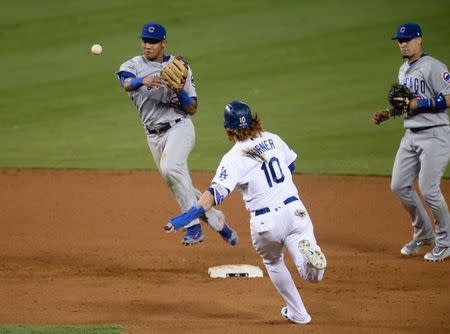 Oct 20, 2016; Los Angeles, CA, USA; Chicago Cubs shortstop Addison Russell (27) turns a double play in the eighth inning against the Los Angeles Dodgers in game five of the 2016 NLCS playoff baseball series against the Los Angeles Dodgers at Dodger Stadium. Mandatory Credit: Gary A. Vasquez-USA TODAY Sports