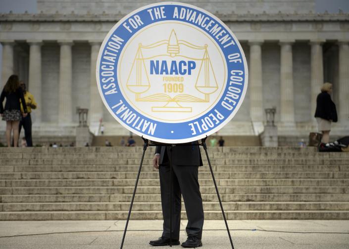 A sign with the logo of the National Association for the Advancement of Colored People (NAACP), is seen during a rally at the Lincoln Memorial on the National Mall in Washington, DC. (BRENDAN SMIALOWSKI/AFP via Getty Images)