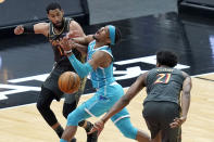 Charlotte Hornets' Devonte' Graham, center, is fouled by Chicago Bulls' Thaddeus Young (21) as Bulls' Garrett Temple also defends during the first half of an NBA basketball game Thursday, April 22, 2021, in Chicago. (AP Photo/Charles Rex Arbogast)