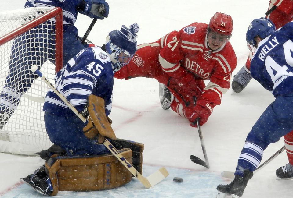 Toronto Maple Leafs goalie Jonathan Bernier (45) blocks a shot by Detroit Red Wings left wing Tomas Tatar (21), of the Czech Republic, during the first period of the Winter Classic outdoor NHL hockey game at Michigan Stadium in Ann Arbor, Mich., Wednesday, Jan. 1, 2014. (AP Photo/Carlos Osorio)