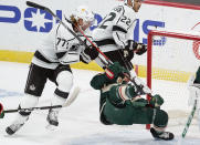 Minnesota Wild's Jared Spurgeon, right, is upended by Los Angeles Kings' Jeff Carter (77) in the first period of an NHL hockey game, Tuesday, Jan. 26, 2021, in St. Paul, Minn. (AP Photo/Jim Mone)