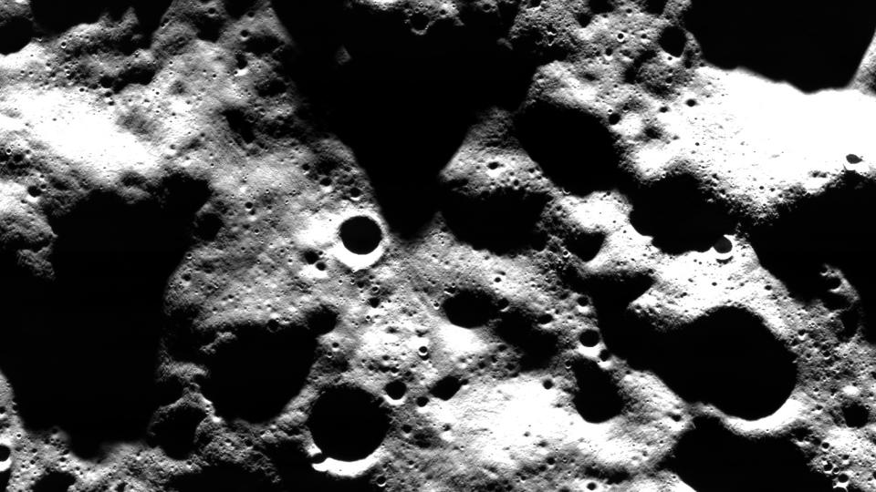  Black and white image of moon close up. 