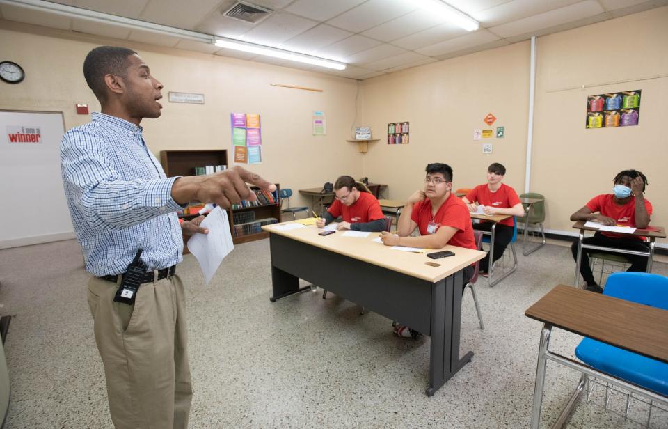 New executive director Pierre Cotton, left, teaches a GED math class at AMIkids in Pensacola on Tuesday, Feb. 14, 2023.