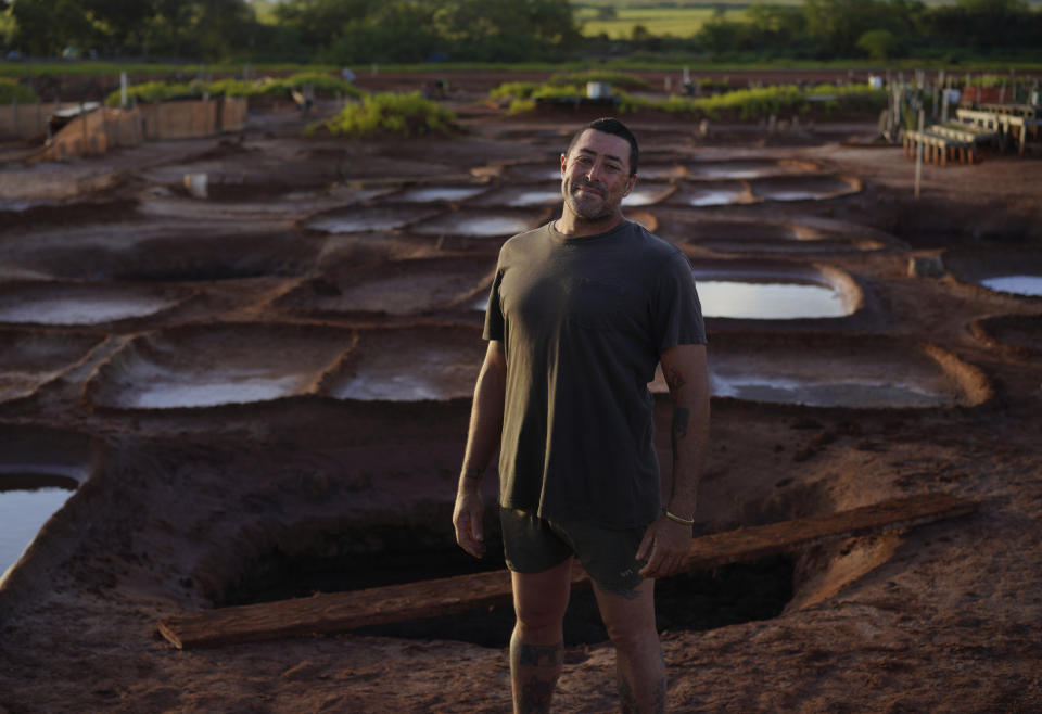 Kanani Santos stands for a portrait near his family's salt beds used in making Native Hawaiian salt on Sunday, July 9, 2023, in Hanapepe, Hawaii. (AP Photo/Jessie Wardarski)