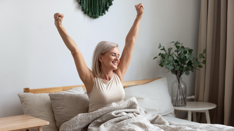 woman stretching in bed