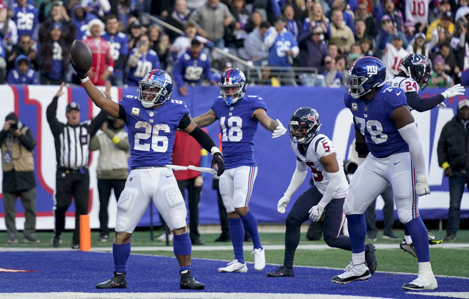New York Giants running back Saquon Barkley (26) celebrates after scoring a touchdown against the Houston Texans during the fourth quarter of an NFL football game, Sunday, Nov. 13, 2022, in East Rutherford, N.J. (AP Photo/Seth Wenig)