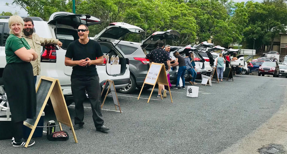 Local farmers lined up with their car boots open.