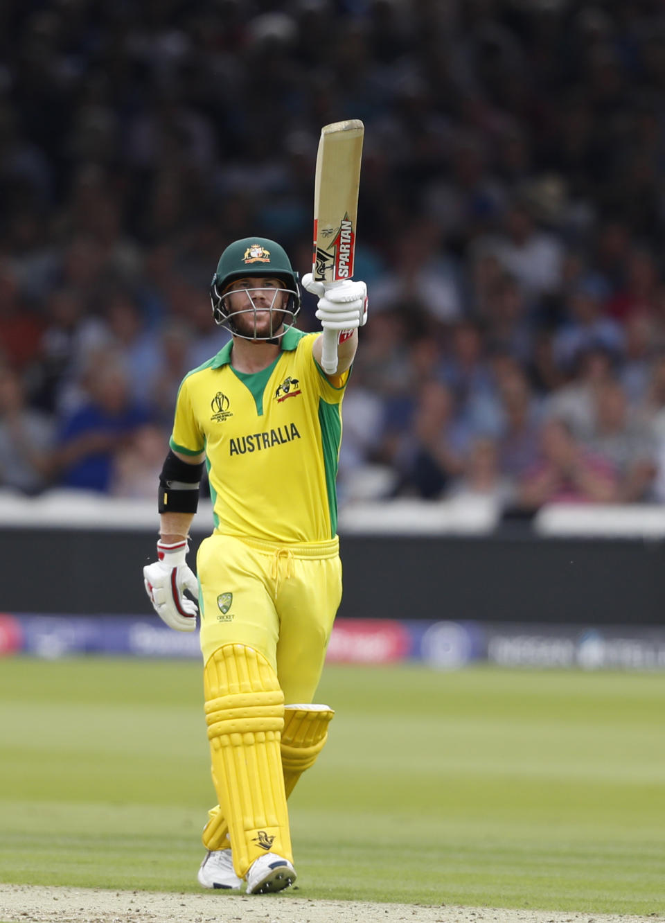 Australia's David Warner celebrates after getting 50 runs not out during their Cricket World Cup match between England and Australia at Lord's cricket ground in London, Tuesday, June 25, 2019. (AP Photo/Alastair Grant)