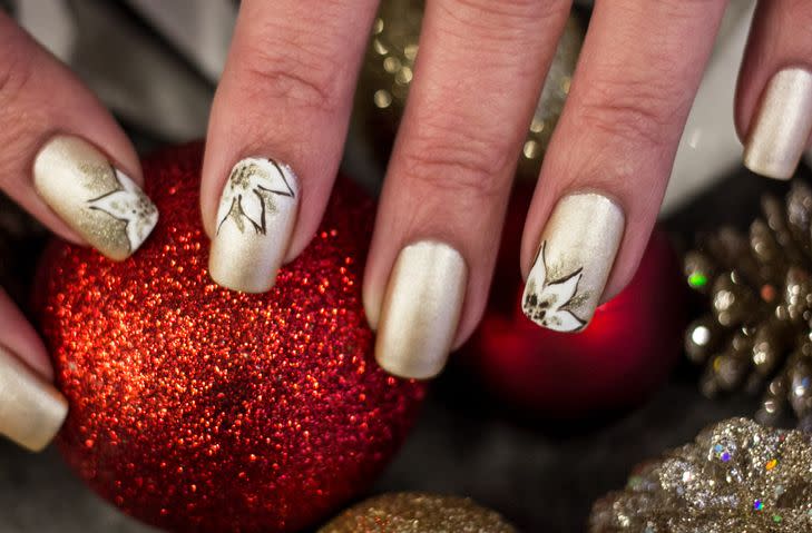 christmas inspired art that is gold with white poinsettias painted on