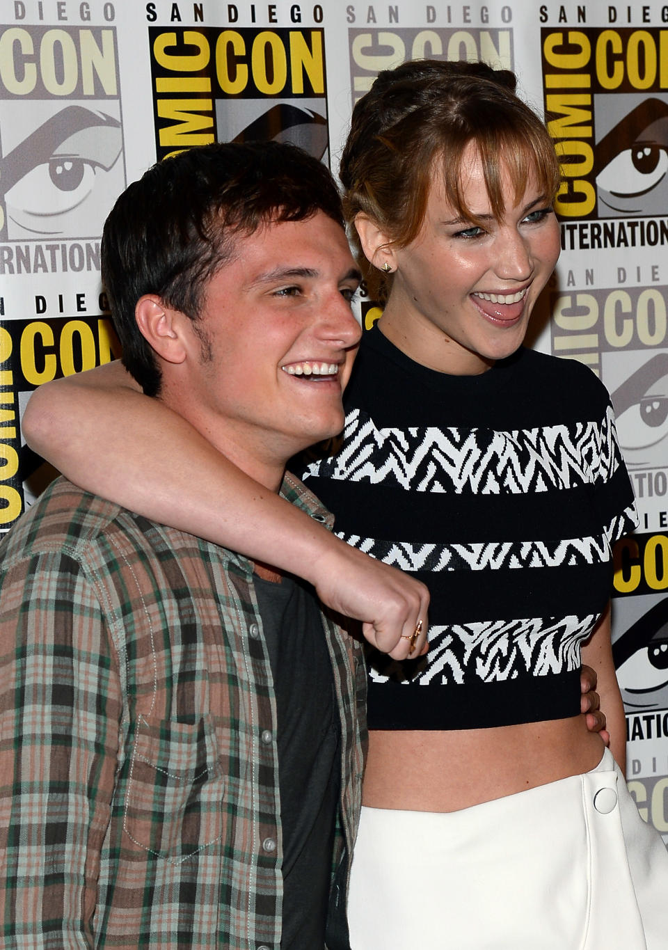 Jennifer smiles widely as she has her arm around Josh's shoulders on the red carpet