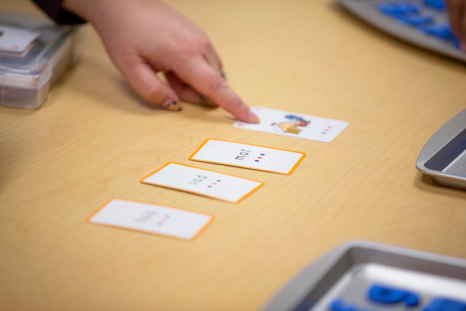 Teacher Caitlin Bruen points to flashcards while teaching a group of first-grade students during an intensive reading class at Freedom Elementary School in Buckeye, Arizona, on Nov. 16, 2021.