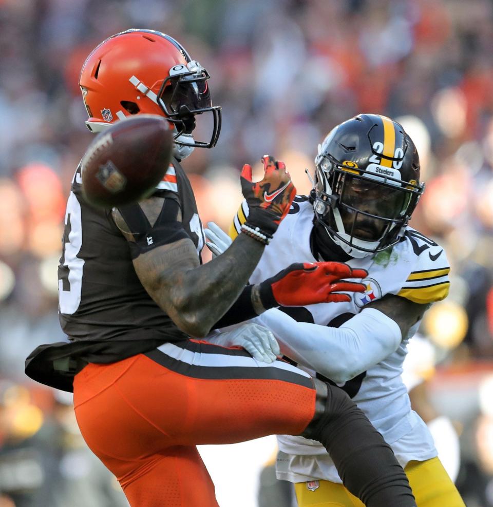 Cleveland Browns wide receiver Odell Beckham Jr. (13) can't hang onto a pass against Pittsburgh Steelers cornerback Cameron Sutton (20) during the second half of an NFL football game, Sunday, Oct. 31, 2021, in Cleveland, Ohio. [Jeff Lange/Beacon Journal]