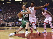 Boston Celtics forward Gordon Hayward (20) drives to the basket as Toronto Raptors guard Kyle Lowry (7) defends during first-half NBA basketball game action in Toronto, Friday, Oct. 19, 2018. (Frank Gunn/The Canadian Press via AP)