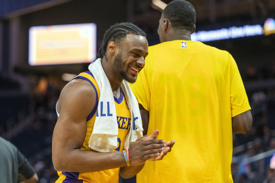 Los Angeles Lakers guard Bronny James cheers after the Lakers score during the first half of an NBA summer league basketball game against the Sacramento Kings in San Francisco, Saturday, July 6, 2024. (AP Photo/Nic Coury)