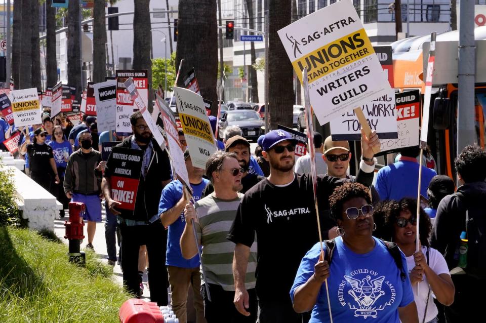 Members of the SAG-AFTRA join a picket line in support of the Writers Guild of America picket outside the Netflix, Inc., building on Sunset Blvd., in the Hollywood neighborhood in Los Angeles, Tuesday, May 2, 2023. The union is seeking higher minimum pay, more writers per show and shorter exclusive contracts, among other demands, all conditions it says have been diminished in the content boom driven by streaming. (AP Photo/Damian Dovarganes)