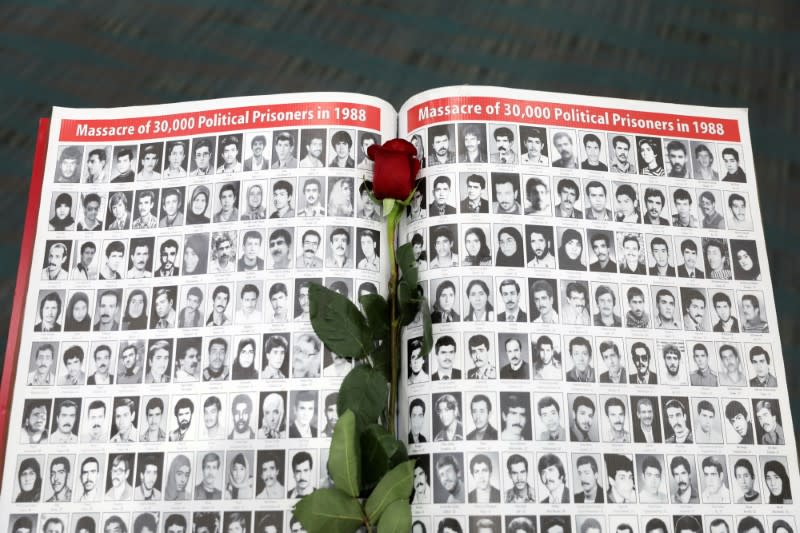 A rose rests on a page featuring photographs of people who have died in Iran as Iranian Americans from across California converge in Los Angeles