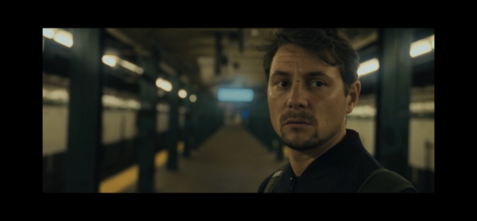 Adam on an empty subway station platform