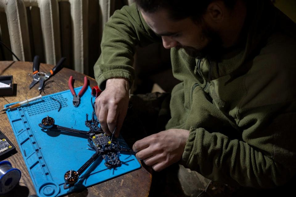 A Ukrainian serviceman works on a FPV drone in a workshop in Donetsk amid a ‘global arms race’ for the technology (Reuters)