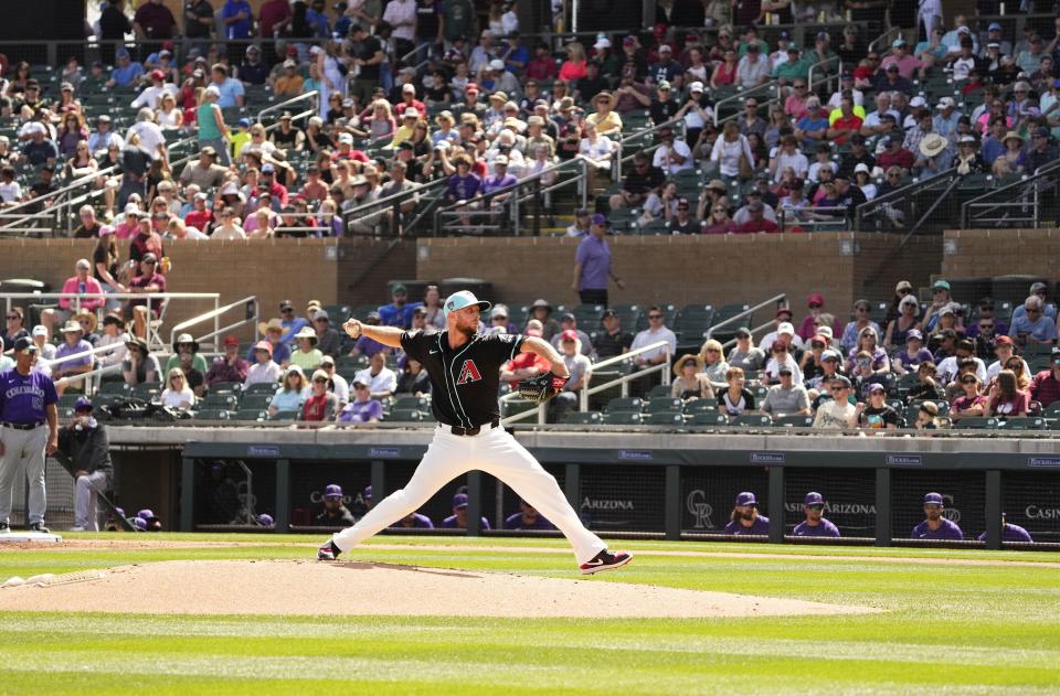 Arizona Diamondbacks starting pitcher Merrill Kelly throws to the Colorado Rockies in the second inning during a spring training game at Salt Rivers Fields on March 13, 2024.