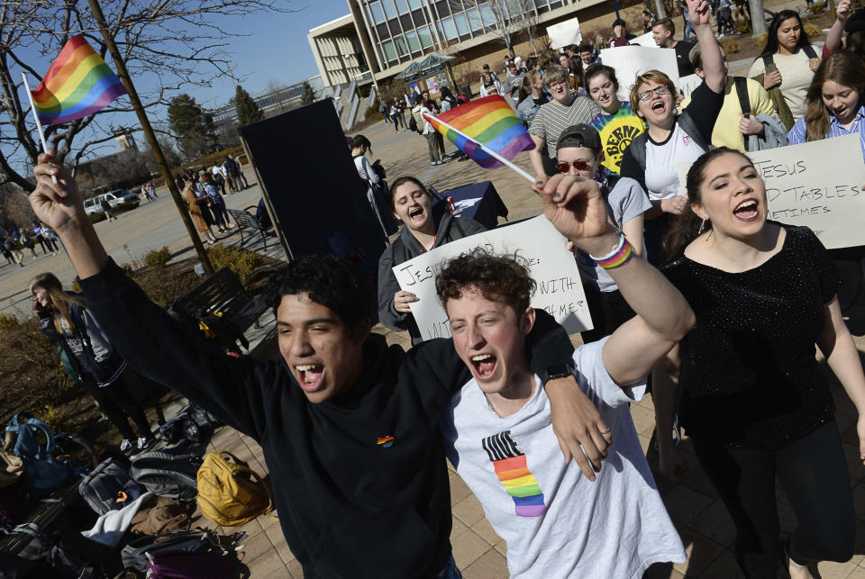 FILE - Lorenzo Larios, left, and Danny Niemann chant "gay rights" as they join a student protest outside the student center at Brigham Young University in Provo, Utah on March 4, 2020. The U.S. Department of Education has opened a civil-rights investigation into how LGBTQ students are disciplined at Brigham Young University, a private religious school. The complaint under investigation came after the school said it would still enforce a ban on same-sex dating even after that section was removed from the written version of the school's honor code, the Salt Lake Tribune reported. (Francisco Kjolseth/The Salt Lake Tribune via AP, File)