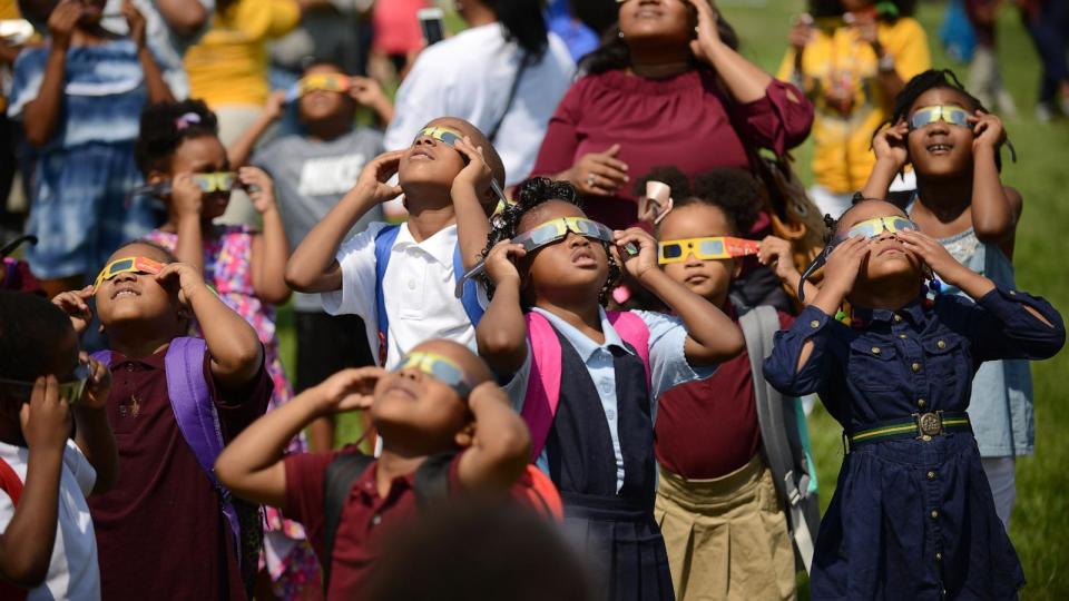 PHOTO: Students at CW Harris Elementary School in SE Washington, D.C., Aug. 21, 2017, use their protective shades to watch the solar eclipse outside their school. ( Astrid Riecken/The Washington Post via Getty Images, FILE)
