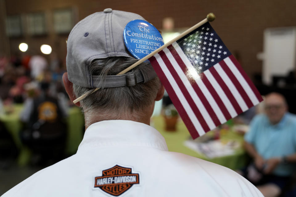 An audience member wears a flag on his hat during U.S. Sen. Joni Ernst's Roast and Ride, Saturday, June 3, 2023, in Des Moines, Iowa. (AP Photo/Charlie Neibergall)