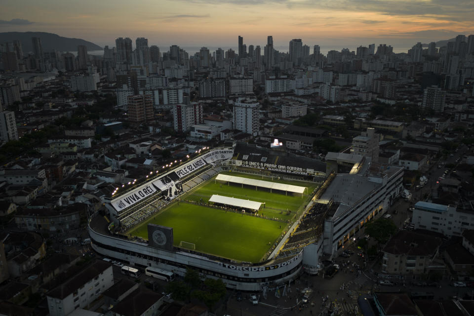 People enter Vila Belmiro stadium where Pele, the late Brazilian soccer great lies in state in Santos, Brazil, Monday, Jan. 2, 2023. (AP Photo/Matias Delacroix)
