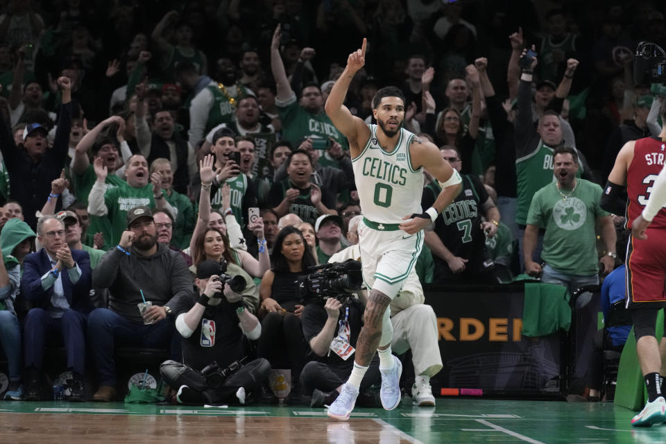 Boston Celtics forward Jayson Tatum (0) reacts after his slam dunk in the first half of game 1 of the NBA basketball Eastern Conference finals playoff series against the Miami Heat in Boston, Wednesday, May 17, 2023. (AP Photo/Charles Krupa)