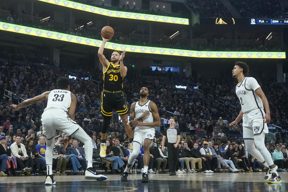 Golden State Warriors guard Stephen Curry (30) shoots against the Brooklyn Nets during the first half of an NBA basketball game in San Francisco, Saturday, Dec. 16, 2023. (AP Photo/Jeff Chiu)