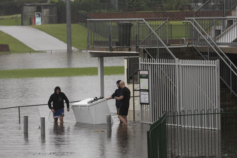 SYDNEY, AUSTRALIA - MARCH 22: Workers at the The Windsor Leagues Club push a fridge out of the kitchen area during heavy flooding on March 22, 2021 in Sydney, Australia. Several western suburbs in the Hawkesbury-Nepean valley have been forced to evacuate as river levels and floodwaters continue to rise.  (Photo by Brook Mitchell/Getty Images)