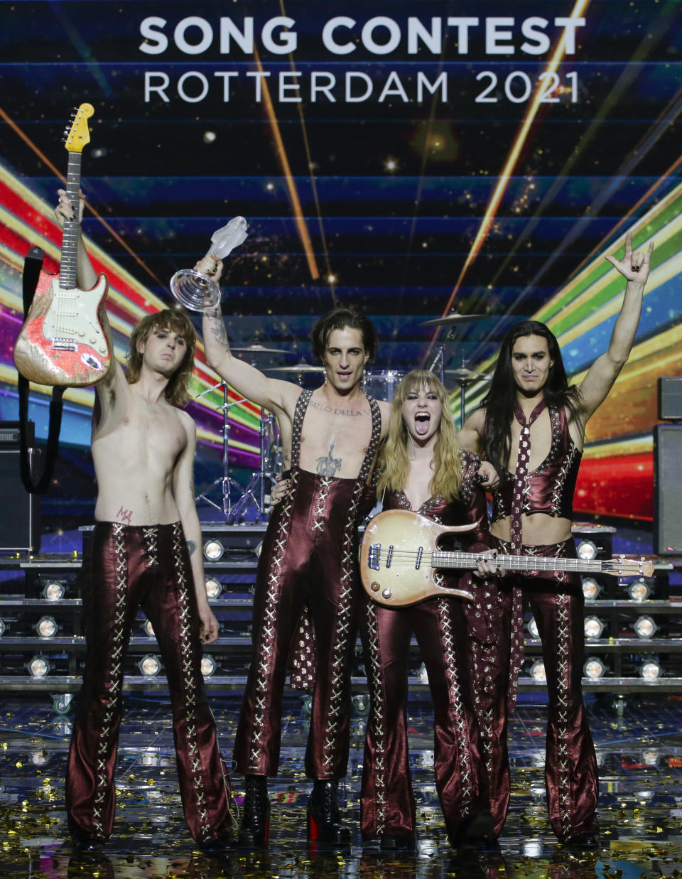 Members of the band Maneskin from Italy guitarist Thomas Raggi, from left, lead vocalist Damiano David, bass player Victoria De Angelis and drummer Ethan Torchio, pose for photographers with the trophy after winning the Grand Final of the Eurovision Song Contest at Ahoy arena in Rotterdam, early Sunday, May 23, 2021. (AP Photo/Peter Dejong)