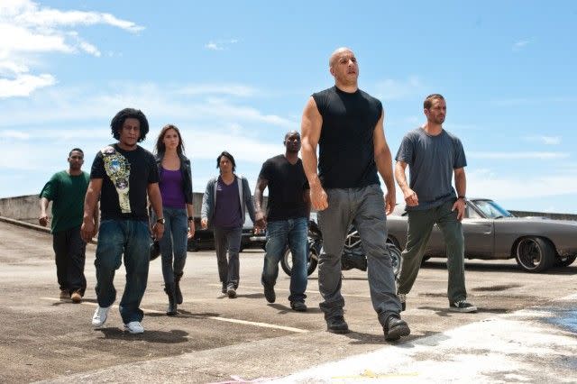 dom and his team walks with tough expressions on their faces in a scene from fast five