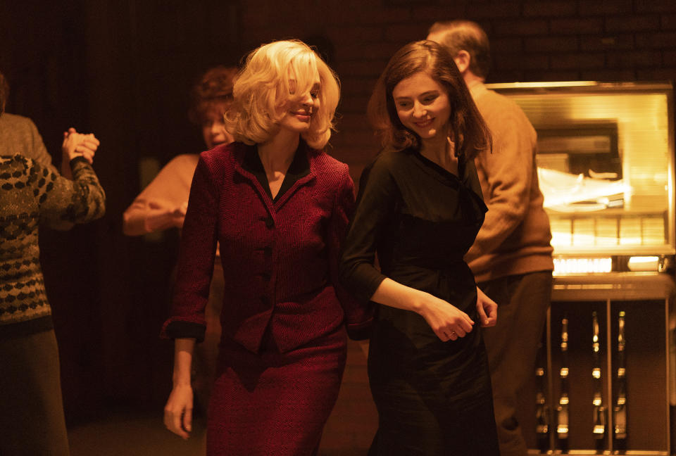 This image released by Neon shows Anne Hathaway, left, and Thomasin McKenzie in a scene from "Eileen." (Jeong Park/Neon via AP)