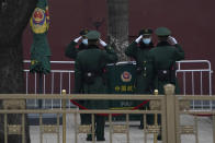 Chinese paramilitary policemen change shifts on the streets of Beijing near the Great Hall of the People on Wednesday, March 3, 2021. In a sign of confidence China has reverted back to holding its annual Congress meetings to march this year after delaying them due to the outbreak of the coronavirus last year. As usual, security has been tightened in the capital with paramilitary troops patrolling near the Great Hall of the People where the meetings are held and standing guard at subway stations. (AP Photo/Ng Han Guan)