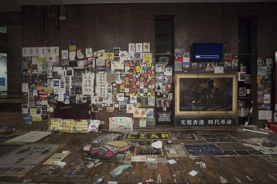 This Thursday, Nov. 21, 2019, photo, shows posters against the government at campus of the Hong Kong Polytechnic University in Hong Kong. Most of the protesters who took over the university have left following clashes with police, but an unknown number have remained inside, hoping somehow to avoid arrest. (AP Photo/Vincent Thian)