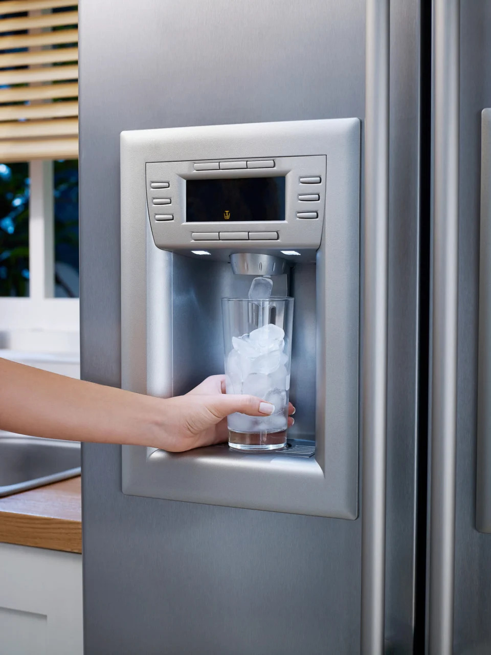 A large fridge with an ice dispenser