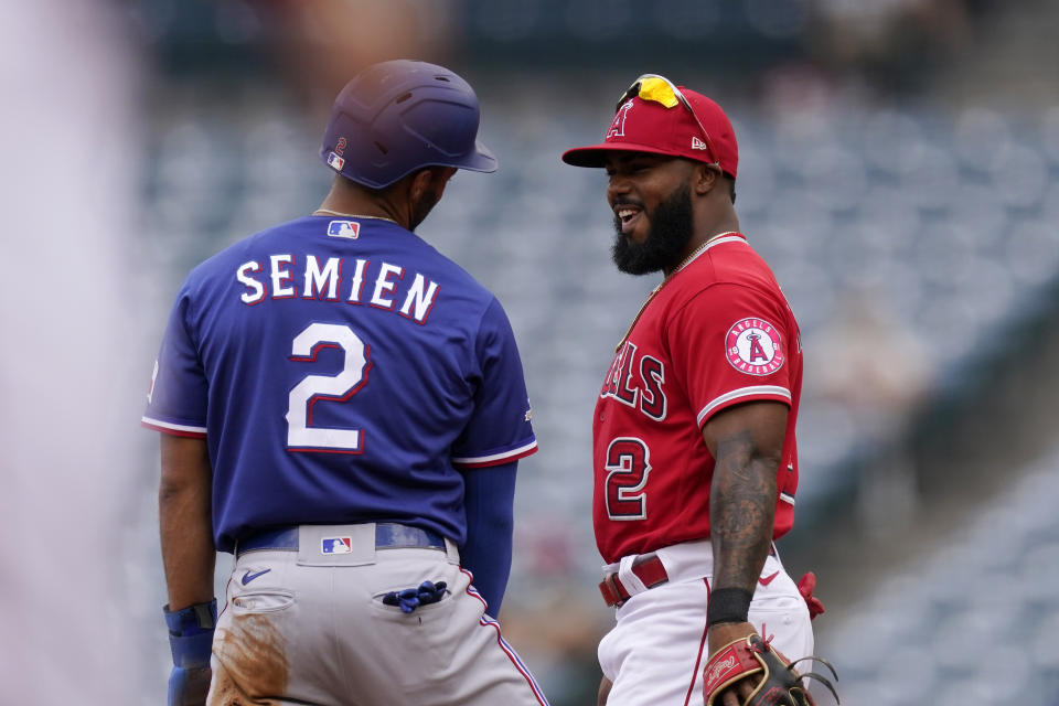 Texas Rangers' Marcus Semien, left, chats with Los Angeles Angels second baseman Luis Rengifo after Semien stole second during the first inning of a baseball game Sunday, July 31, 2022, in Anaheim, Calif. (AP Photo/Mark J. Terrill)
