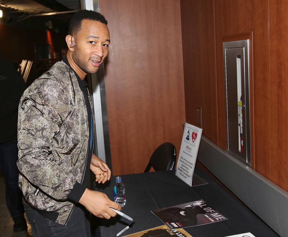 <p>John Legend was spotted signing a few pieces of memorabilia for the annual Grammys charity auction. Funds raised go towards the Grammy Foundation and MusicCares, which “provides a safety net of critical assistance for music people in times of need.” (Photo: Maury Phillips/WireImage) </p>