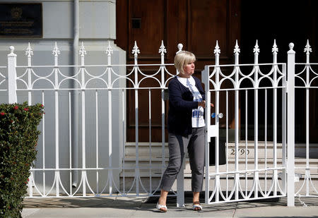 An unidentified woman stands at a gate at the entrance to the building of the Consulate General of Russia in San Francisco, California, U.S., August 31, 2017. REUTERS/Stephen Lam