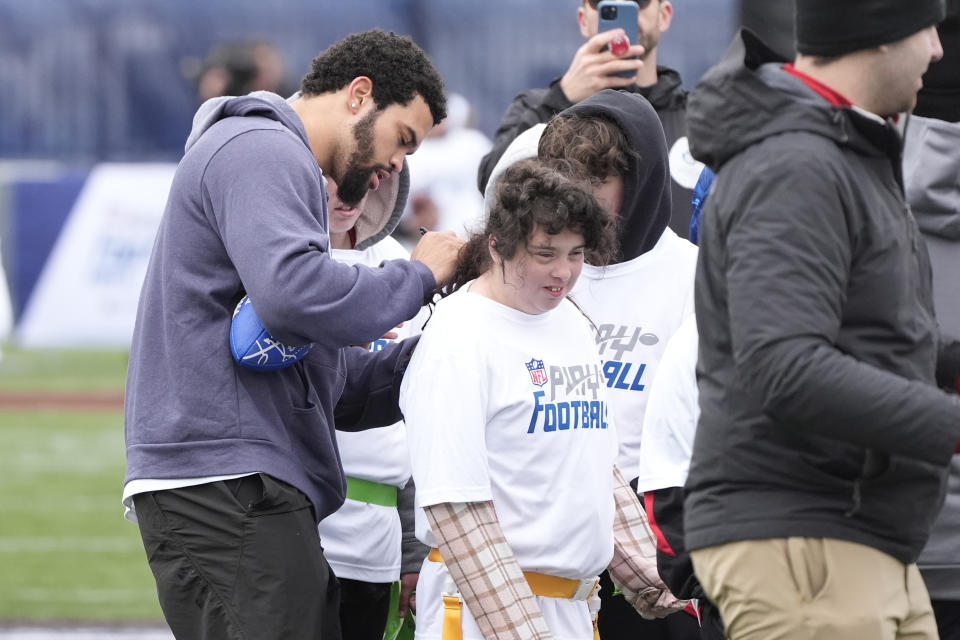 USC quarterback Caleb Williams autographs an athlete's shirt during an NFL Football Play Football Prospect Clinic with Special Olympics athletes, Wednesday, April 24, 2024 in Detroit. (AP Photo/Carlos Osorio)