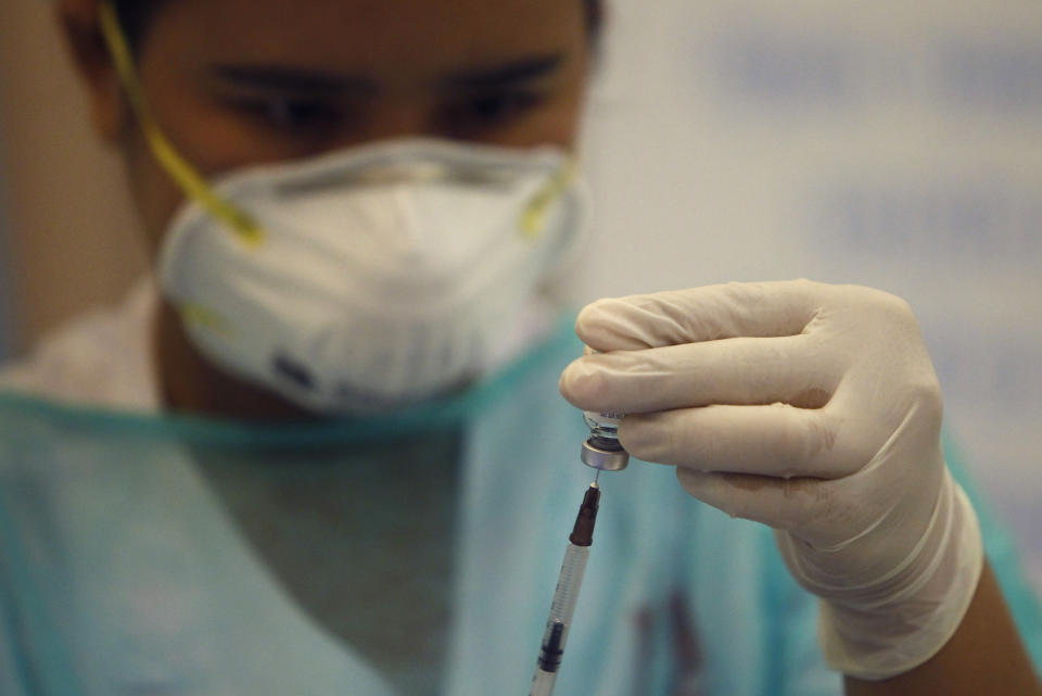 A Cambodian nurse prepares the COVID-19 vaccine at Calmette hospital in Phnom Penh, Cambodia, Wednesday, Feb. 10, 2021. Cambodia began its inoculation campaign against the COVID-19 virus with vaccines donated from China, the country’s closest ally. (AP Photo/Heng Sinith)