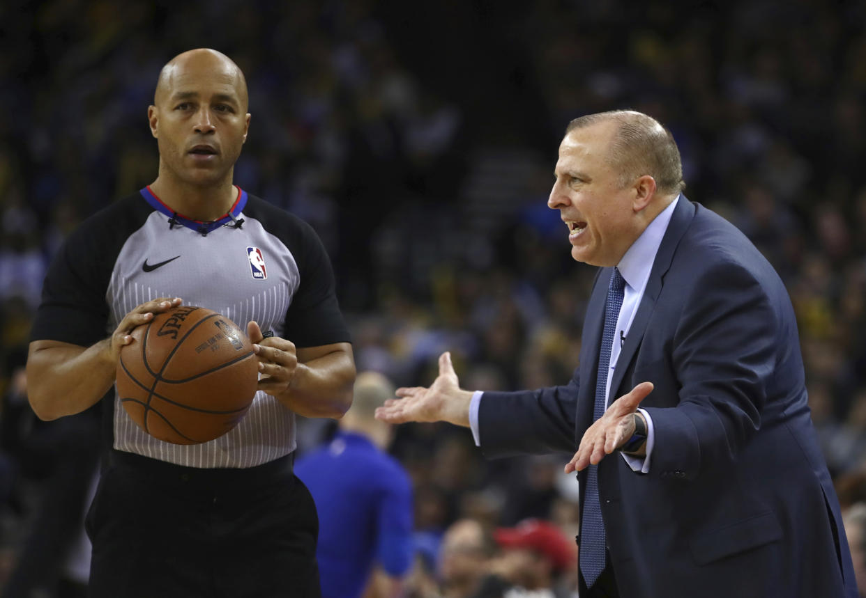 Referee Marc Davis works on his conflict resolution with Timberwolves coach Tom Thibodeau. (AP)