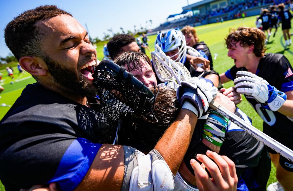 Community School of Naples Seahawks players celebrate defeating the St. Andrew's Scots in overtime of the Class 1A state semifinal at Paradise Coast Sports Complex in Naples on Thursday, May 9, 2024.