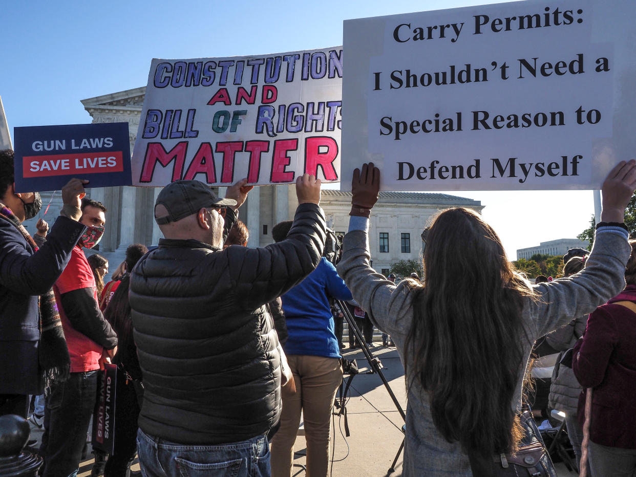 Supporters and opponents of strong gun control laws rally outside the US Supreme Court