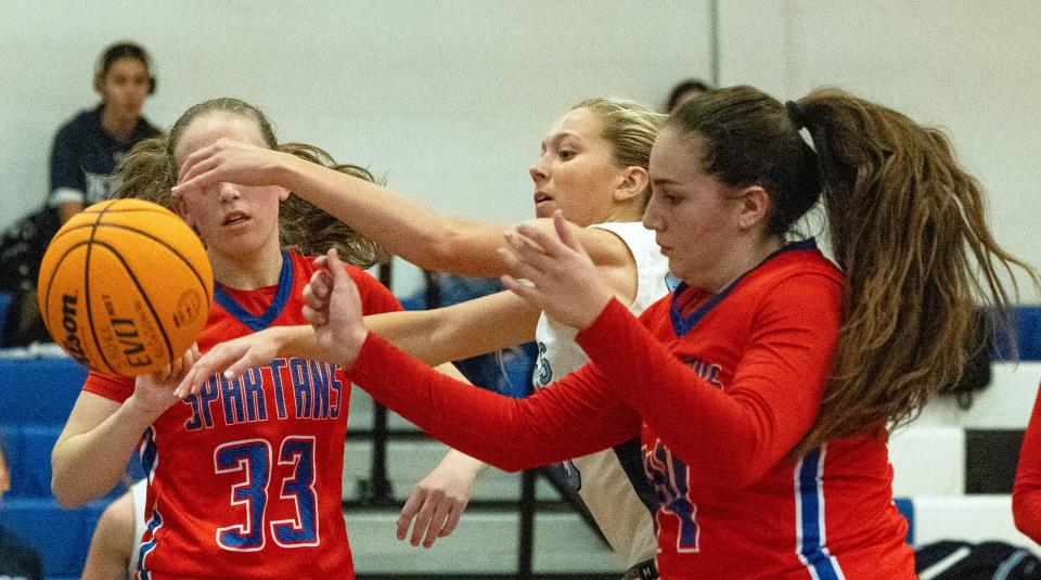 Freehold Sophie Tonino battles with Sofia Bhebookjian for a rebound. Ocean Twp. Girls Basketball defeats Freehold Township in Blue Devil Holiday Invitational in West Long Branch on December 28, 2023.