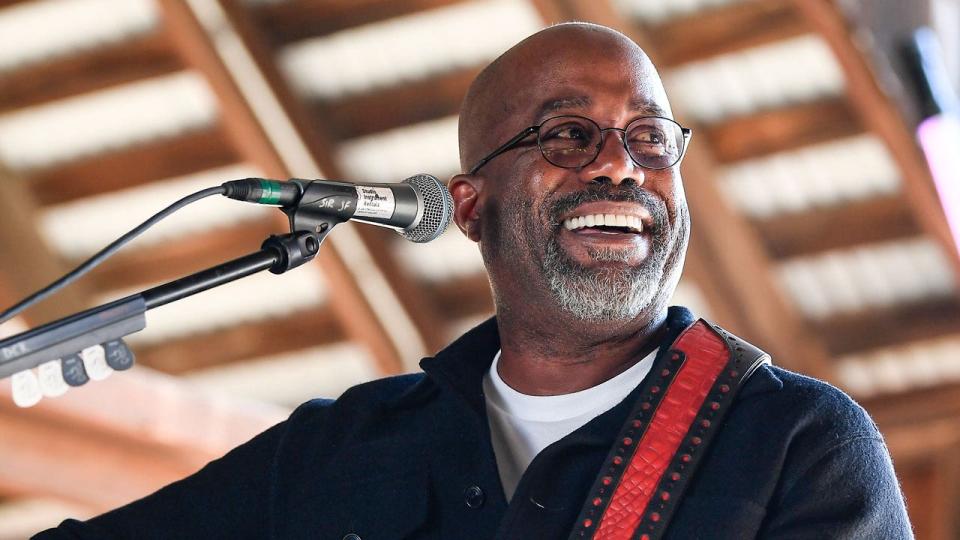 Darius Rucker smiles while performing.