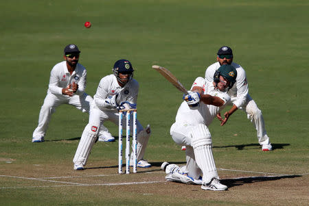 Cricket - India v Australia - First Test cricket match - Maharashtra Cricket Association Stadium, Pune, India - 23/02/17. Australia's Mitchell Starc plays a shot. REUTERS/Danish Siddiqui