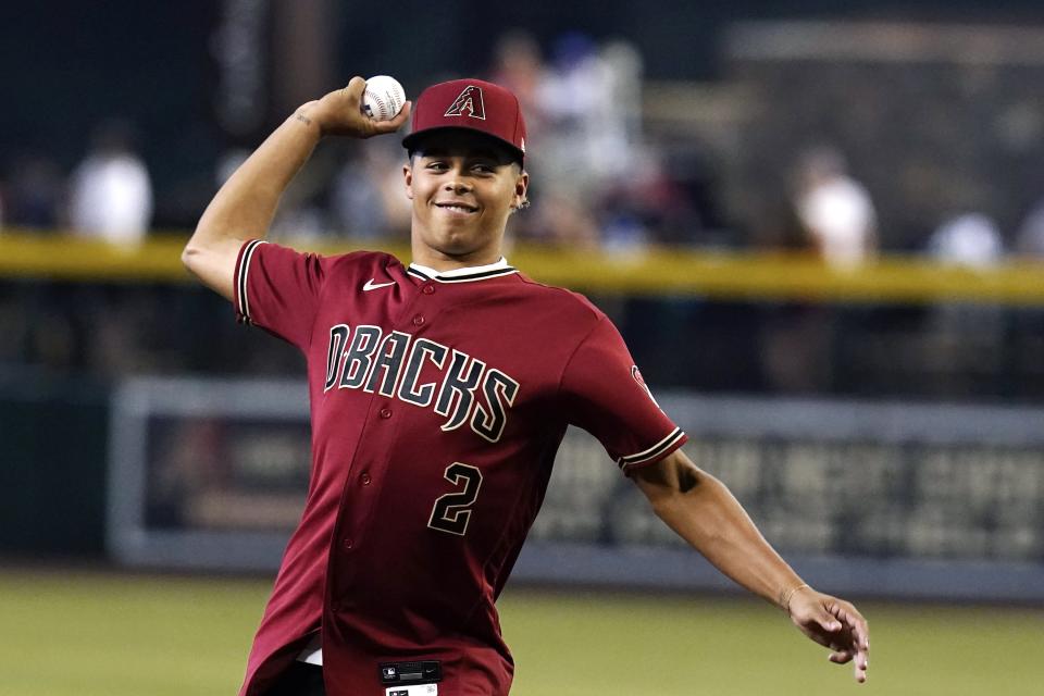 Arizona Diamondbacks first round MLB draft pick Druw Jones throws out the first pitch prior to a baseball game against the Washington Nationals Saturday, July 23, 2022, in Phoenix. (AP Photo/Ross D. Franklin)