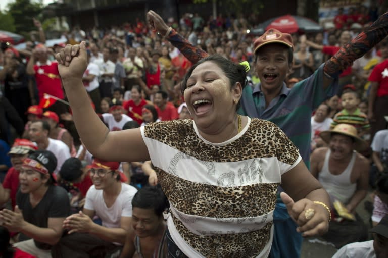 Supporters of Myanmar opposition leader Aung San Suu Kyi celebrate as they hear the first official results of the elections on a giant screen outside the National League of Democracy party headquarters in Yangon on November 9, 2015